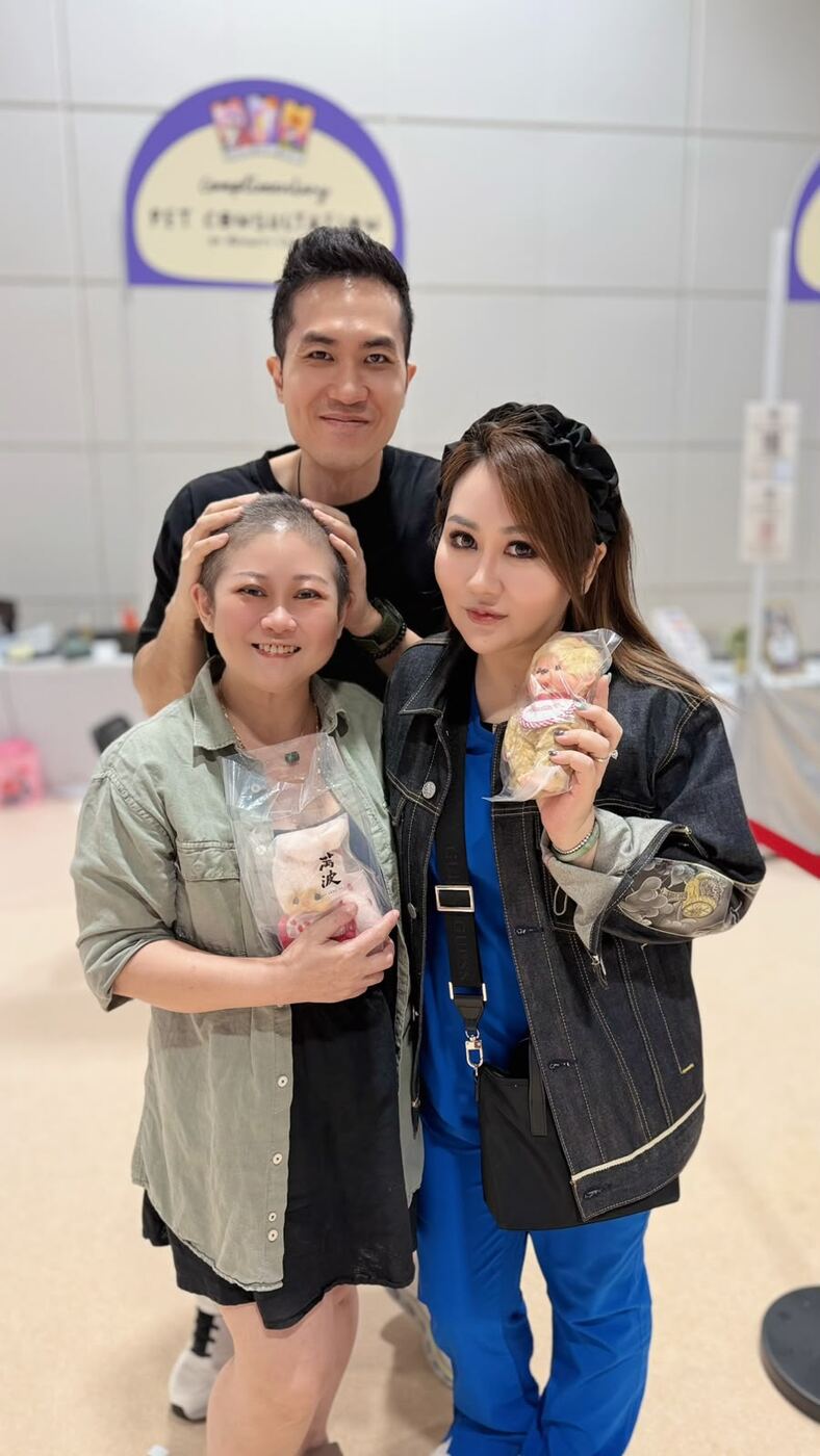 Jessica Woo with two other people at a pet consultation event in Singapore, each holding a small plush toy